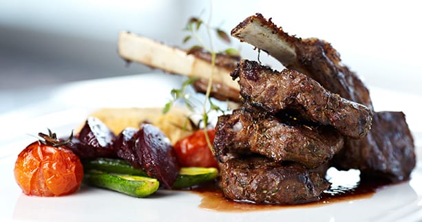 HERB CRUSTED RACK OF LAMB WITH BLUEBERRY GASTRIQUE