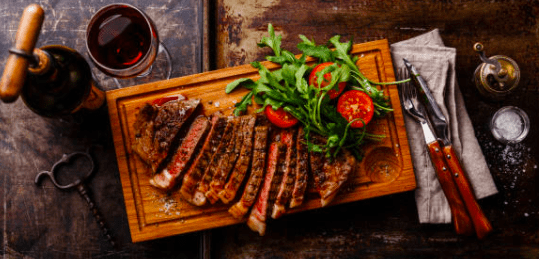 steak wine and veggies
